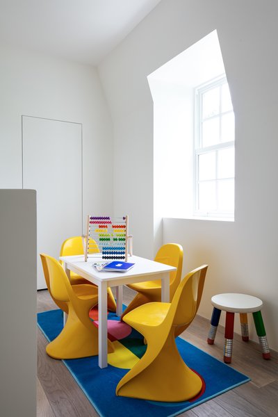 The children's play space has bold yellow Panton junior chairs. 