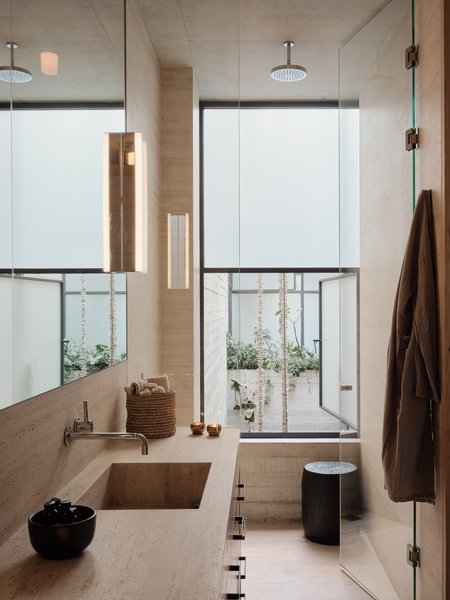 The vanities and bathroom walls are made from locally sourced travertine slabs.