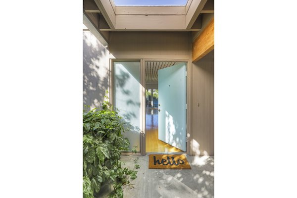 A skylight over the entrance sets the tone for a breezy interior.