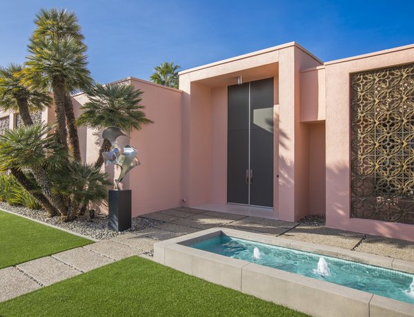 The home's pretty pink facade is offset by aluminum grilles. Providing shade as well as decoration, the grilles were designed by John deKoven Hill, lead architect in the office of Frank Lloyd Wright who took over the firm upon Wright&rsquo;s passing in 1959. "We believe that the screens were a choice of the original owners as indicated by the plans," says listing agent Chris Menrad.