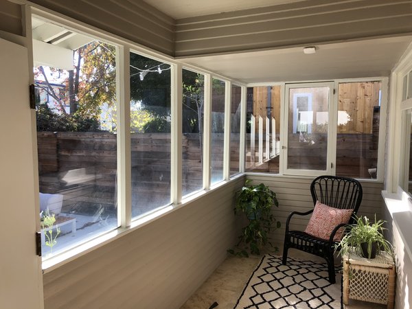 Leaving the front door in place, the renovation would remove the wall that separated the sunporch from the living room.