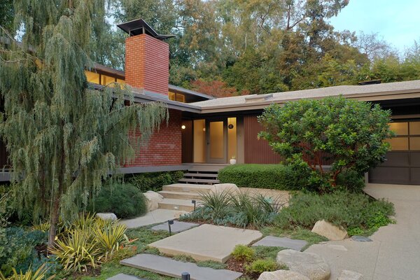 Stone pavers lead up to the front entrance of the beautifully updated home. 