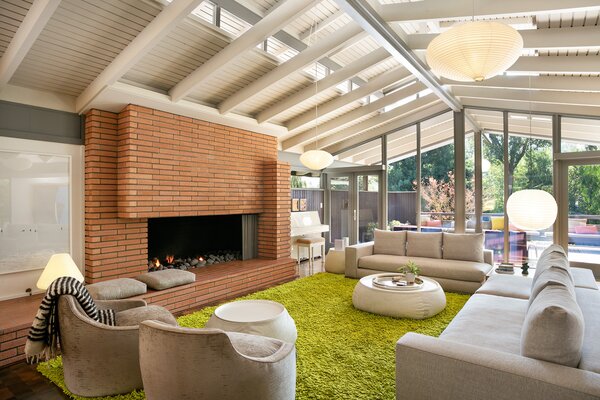 The light-filled living room features extensive glazing in the form of clerestory windows, skylights, and a brilliant wall of glass. 