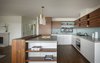 Modern home with Kitchen, Cooktops, Microwave, Refrigerator, Wood Counter, Wood Cabinet, Engineered Quartz Counter, White Cabinet, Pendant Lighting, Ceramic Tile Backsplashe, Undermount Sink, Range, Medium Hardwood Floor, Wall Oven, and Dishwasher. Kitchen Photo 2 of 51 Nebraska