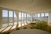 Modern home with Living Room, Sectional, Sofa, and Light Hardwood Floor. Folding glass NanaWall system in living room overlooking Atlantic Ocean Photo of Mulberry Point House