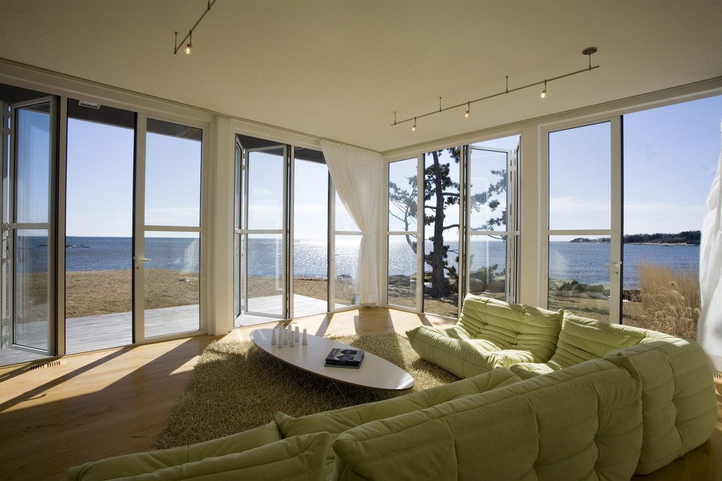 Folding glass NanaWall system in living room overlooking Atlantic Ocean