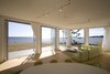 Modern home with Living Room, Sofa, Sectional, Pendant Lighting, and Medium Hardwood Floor. Folding glass NanaWall system in living room overlooking Atlantic Ocean Photo 5 of Mulberry Point House