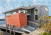 Modern home with Exterior, Vinyl Siding Material, Metal Siding Material, Concrete Siding Material, Metal Roof Material, House Building Type, and Boathouse Building Type. Exterior of Houseboat H Photo of Houseboat H