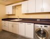 Modern home with Laundry Room, Laminate Counter, White Cabinet, and Side-by-Side. Laundry room area with white cabinets and energy efficient washing machine Photo 8 of Houseboat H