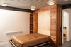 Modern home with Bedroom, Bed, Ceiling Lighting, Concrete Floor, and Storage. Murpy bed, Epic decking ceiling, guest powder room, polished concrete floors in the full-height concrete float basement Photo 17 of Houseboat H