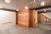 Modern home with Living Room and Ceiling Lighting. Full height concrete basement float with Murphy bed, shelving unit, under-stairs wine cellar, Epic decking ceiling, and polished concrete floors Photo 2 of Houseboat H