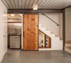 Modern home with Storage Room, Under Stairs Storage Type, and Closet Storage Type. Under ceiling wine cellar, exposed structural beam, cable railing, closet made of the wood salvaged from the original 100-year old houseboat Photo 5 of Houseboat H
