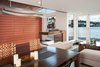 Modern home with Dining Room, Concrete Floor, Gas Burning Fireplace, Pendant Lighting, Two-Sided Fireplace, and Table. Dining room table, opening glass NanaWall system, recessed lighting Photo 13 of Houseboat H