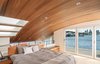 Modern home with Bedroom, Bed, Bench, Light Hardwood Floor, and Recessed Lighting. Ceiling finished with wood from the original, 100-year old houseboat that burned down, opening glass NanaWall system WA67, balcony Photo 15 of Houseboat H