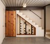 Modern home with Storage Room, Under Stairs Storage Type, and Closet Storage Type. Under stair wine cellar with closet finished with wood salvaged from the original, 100-year old houseboat float, Epic decking ceiling, cable railing, and bamboo treads on stairs to main level, polished concrete floors Photo 20 of Houseboat H