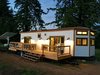 Modern home with Exterior, Prefab Building Type, House Building Type, Gable RoofLine, and Metal Roof Material. Tiny Happy House with large deck, two-sided gas fireplace, and opening glass NanaWall systems. Photo of Iki Hau'oli Hale (Tiny Happy Home)