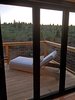 Modern home with Doors, Exterior, Metal, and Folding Door Type. Opening glass NanaWall system, lounge chair, forest view Photo 20 of Iki Hau'oli Hale (Tiny Happy Home)