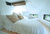 Modern home with Bedroom, Recessed Lighting, Light Hardwood Floor, and Bed. Guest bedroom in the hidden loft above the full-size chef's kitchen Photo 2 of Iki Hau'oli Hale (Tiny Happy Home)