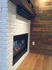 Modern home with Living Room, Gas Burning Fireplace, Medium Hardwood Floor, and Two-Sided Fireplace. Double-sided fireplace, reclaimed wood mantle and wall Photo 9 of Iki Hau'oli Hale (Tiny Happy Home)