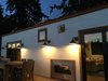 Modern home with Exterior, Wood Siding Material, Metal Roof Material, House Building Type, A-Frame RoofLine, and Prefab Building Type. Large deck with two-sided fireplace, opening glass NanaWall systems, dining area Photo 17 of Iki Hau'oli Hale (Tiny Happy Home)