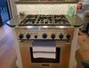 Modern home with Kitchen, Engineered Quartz Counter, Cooktops, and Range. Five burner chef's stove top, storage, and bar seating are Photo 14 of Iki Hau'oli Hale (Tiny Happy Home)