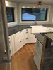 Modern home with Kitchen, Metal Backsplashe, Range, White Cabinet, Cooktops, Recessed Lighting, Refrigerator, Light Hardwood Floor, Engineered Quartz Counter, Pendant Lighting, and Drop In Sink. Full-sized chef's kitchen, 19' of quart composite counter tops, full-sized refrigerator, white cabinets, five burner gas stove Photo 15 of Iki Hau'oli Hale (Tiny Happy Home)