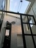 Modern home with Bath Room, Porcelain Tile Wall, Enclosed Shower, Porcelain Tile Floor, Marble Counter, and Track Lighting. Skylight in the roof above the enclosed, circulating shower Photo 5 of Iki Hau'oli Hale (Tiny Happy Home)