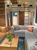 Modern home with Living Room, Light Hardwood Floor, Gas Burning Fireplace, Sofa, Track Lighting, and Two-Sided Fireplace. Living room and door to master bedroom, Chesterfield sofa, Dutch door Photo 11 of Iki Hau'oli Hale (Tiny Happy Home)