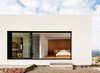 The master suite's multi-slide door seamlessly merges the interior of the upper volume with the rugged landscape outside. Photo 5 of West Texas Vistas modern home