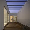 Modern home with Metal, Sliding Door Type, Interior, Outdoor, Side Yard, Pavers Patio, Porch, Deck, Hardscapes, and Stone Patio, Porch, Deck. “We all like to think of architecture in the daytime,” says architect Michael Kothke. “But this house is equally impressive at night.” Photo of Custom Cat House