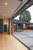 This view of the main living area from inside the master bedroom shows how two 90-degree multi-slide doors seamlessly blend the indoors with the outside. Photo 3 of A Perfect Match modern home