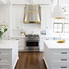 Modern home with Kitchen, Engineered Quartz Counter, Cooktops, Range, and Range Hood. Side-by-side islands & ornate range hood make this kitchen beautiful and functional. Photo 5 of Spacious Tennessee Kitchen
