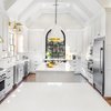 Modern home with Kitchen, Engineered Quartz Counter, Ceiling Lighting, Refrigerator, White Cabinet, Medium Hardwood Floor, Range, Cooktops, and Dishwasher. Double islands featuring Cambria Torquay™ make entertaining and meal prep enjoyable. Photo 2 of Spacious Tennessee Kitchen