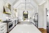 Modern home with Kitchen, Engineered Quartz Counter, White Cabinet, and Medium Hardwood Floor. Double islands featuring Cambria Torquay™ make entertaining and meal prep enjoyable. Photo of Spacious Tennessee Kitchen