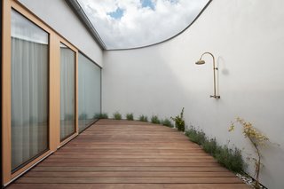 The outdoor atrium of Family House Litvínovice is a completely private space that's well-suited for the installation of a hammock, outdoor bath, or shower. A11 designed the home to be an exploration of minimalism and privacy from the outside world.