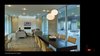 Modern home with Chair, Coffee Tables, Ceiling Lighting, Accent Lighting, Pendant Lighting, Concrete Floor, Standard Layout Fireplace, Gas Burning Fireplace, Bar, Stools, Table, Back Yard, Hardscapes, and Small Patio, Porch, Deck. Living Room Opens onto Terrace Photo 11 of The Graphic House