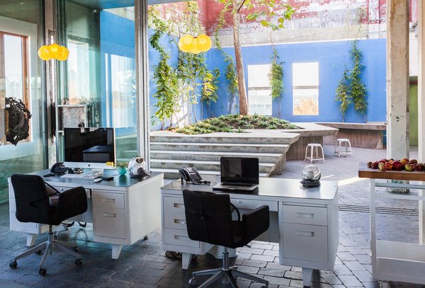 Sliding glass doors surround the spacious courtyard. In the summer, the doors are pushed open and staff can sit on the concrete ledges outside.