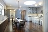 A view from the stair landing looking toward the dining and kitchen areas. The home office / guest room and the hallway to the living room are in the background. We had a great experience with the very talented team at Lindsey Adelman Studios who designed the Branch chandelier on site with a mockup before finalizing the design. This photo also highlights the beautiful select grade American black walnut floor supplied by LV Wood which was sanded and finished on site. The floor is plain sawn, our go to for walnut flooring. It also has no sap wood a specific request by our client. Photo 3 of White Street Residence modern home
