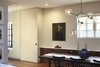 Afternoon sunlight filters through the steel windows in this view looking toward the children's playroom. In all of our projects we design the lighting specific to our client's artwork. Here one of our favorites an LED Bevel tape-in fixture by USA Iluminations highlights a beautiful painting, c. 1900, of a cowboy. Photo 10 of White Street Residence modern home
