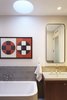 A detail photo of the master bath in the penthouse addition. Here highlighting some of our favorites - tile from Heath Ceramics, plumbing fittings by Dornbracht, bathtub and sink by Duravit and an Arne Jacobsen hand towel ring by Vola. The medicine cabinet was custom made to our specifications and has a cold rolled blackened steel frame. Photo 6 of White Street Residence modern home