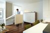 An action photo of the fold down table - highlighting a few of our favorites, walnut flooring @lv_wood, Hella Jongerius fabric @maharamstudio and a custom bureau built by our go to furniture builder Stephen Iino. The table build-out also houses a subwoofer speaker connected to the AV equipment in the bureau. All wiring is concealed running in a routed channel behind removable wood base. Photo 8 of Riverside Residence modern home