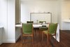 A side view of the fold-down dining table. The table uses counterweights, concealed behind the Maharam fabric panel and was sized specifically for the apartment's ceiling height, comfortably seating four people. Photo 10 of Riverside Residence modern home