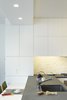 Often we have to work around awkward base building conditions. We removed an existing wall between the kitchen and living room to create a more modern open space - in doing so we needed to reroute a cold water supply line which we located in a new dropped soffit - to help make visual sense of this we aligned the leading edge of the Corian counter below with the soffit above. Photo 13 of Riverside Residence modern home