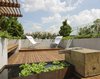 A view from the gravel seating area looking North. The waterfall spout was fabricated in stainless steel and sourced from a restaurant supply vendor located on the Bowery. Photo 7 of East Village Roof Garden modern home