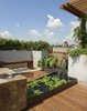 A detail photo of the water garden with rough sawn oak block which forms part of the waterfall and allows one a place to perch. Photo 6 of East Village Roof Garden modern home
