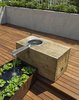 The oak block was sourced from a mill outside of Philadelphia. The block was rough sawn and left unfinished to weather and develop a patina. The lined water trough is fabricated from Cor-Ten steel. Photo 8 of East Village Roof Garden modern home