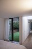 From the master bedroom one can look back down the length of the space through the internal kitchen link or the external courtyard. Photo 4 of Unité de Rénovation modern home