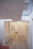 Roof-lights provide views of the sky and loosely delineate the living space from the adjacent entry and dining spaces. Photo 10 of Unité de Rénovation modern home
