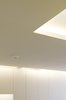 A lowered ceiling conceals fluorescent lighting and enhances the perception of the design as a delicately attached modern architectural intervention. Photo 3 of Periscope modern home
