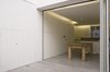 Referencing a traditional building element but using modern detailing, the white-painted wall panelling is continuous from inside to outside. Photo 7 of Periscope modern home